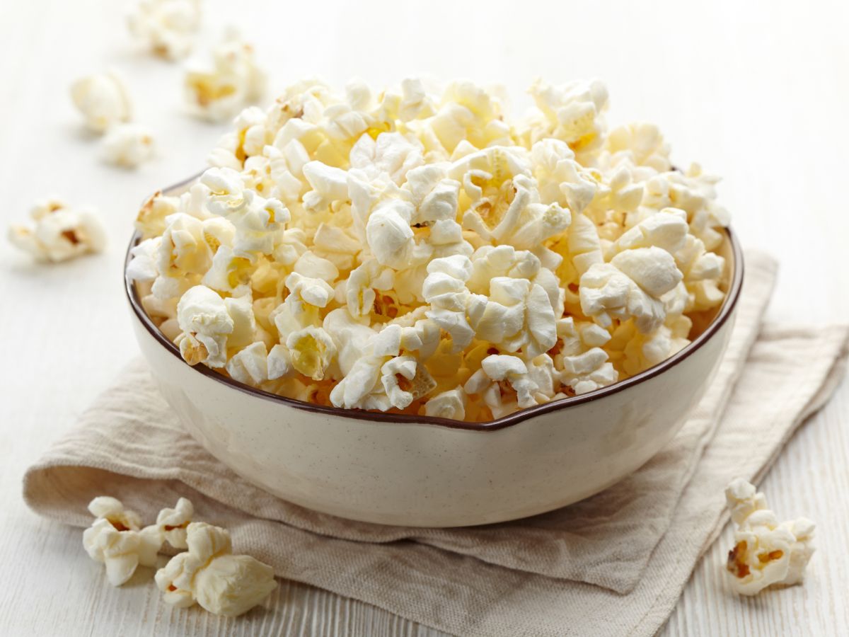 A white bowl full of popcorn.