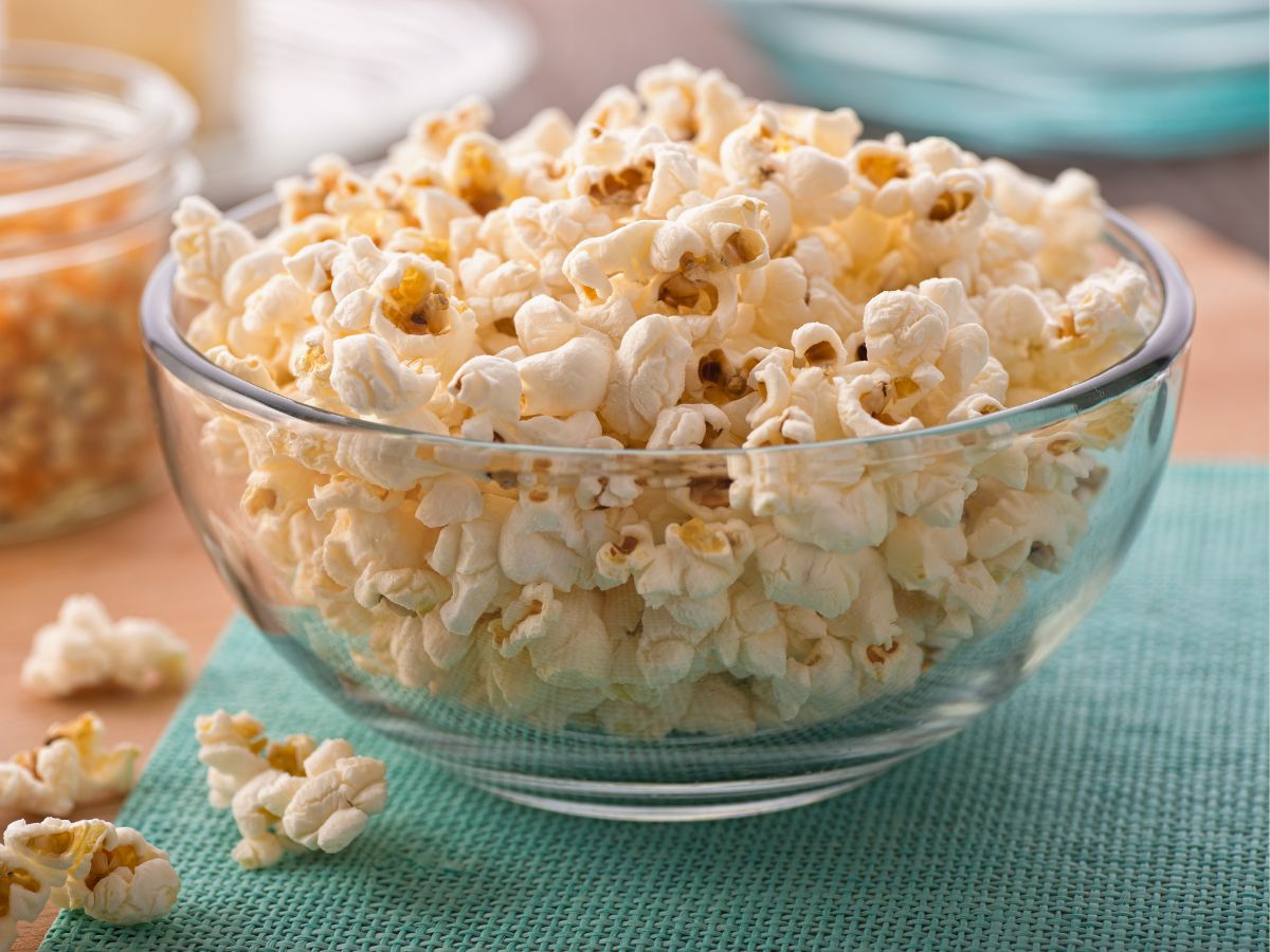 Glass bowl full of popcorn.