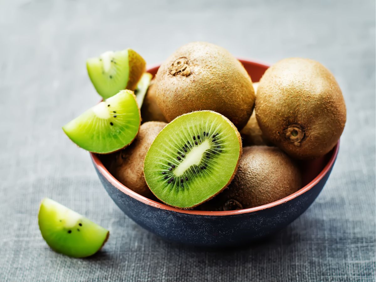 Bowl of fresh organic kiwi fruits on a table.