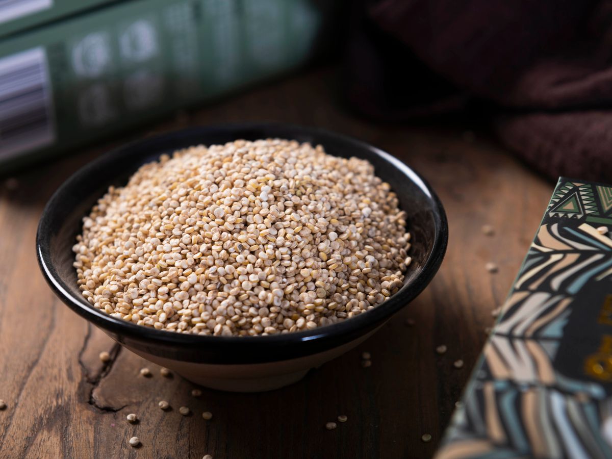 Black bowl of quinoa on a table.