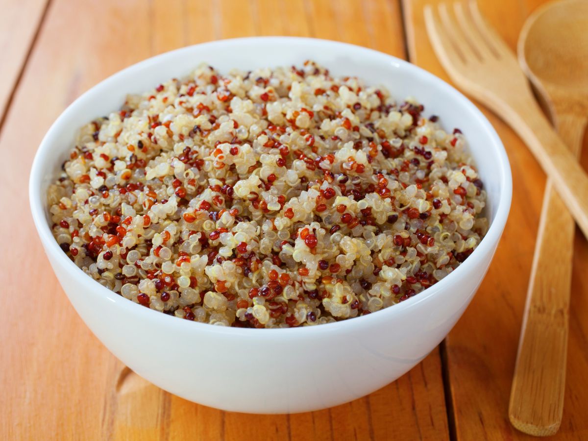 Bowl of cooked quinoa on a table.