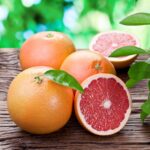 Ripe organic grapefruits on a wooden table.