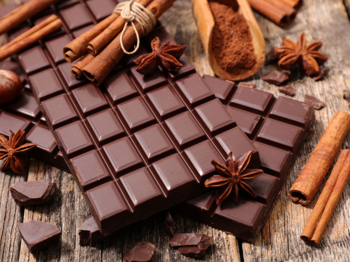 Chocolate bars and cinnamon on a table.