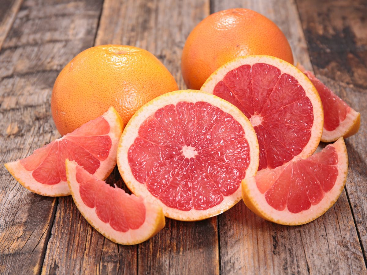 Ripe juicy grapefruits on a wooden table.