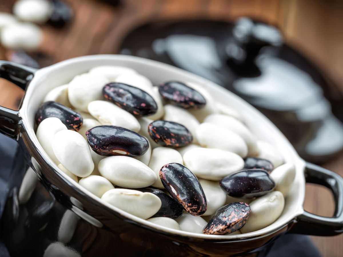 A small pot full of raw beans.