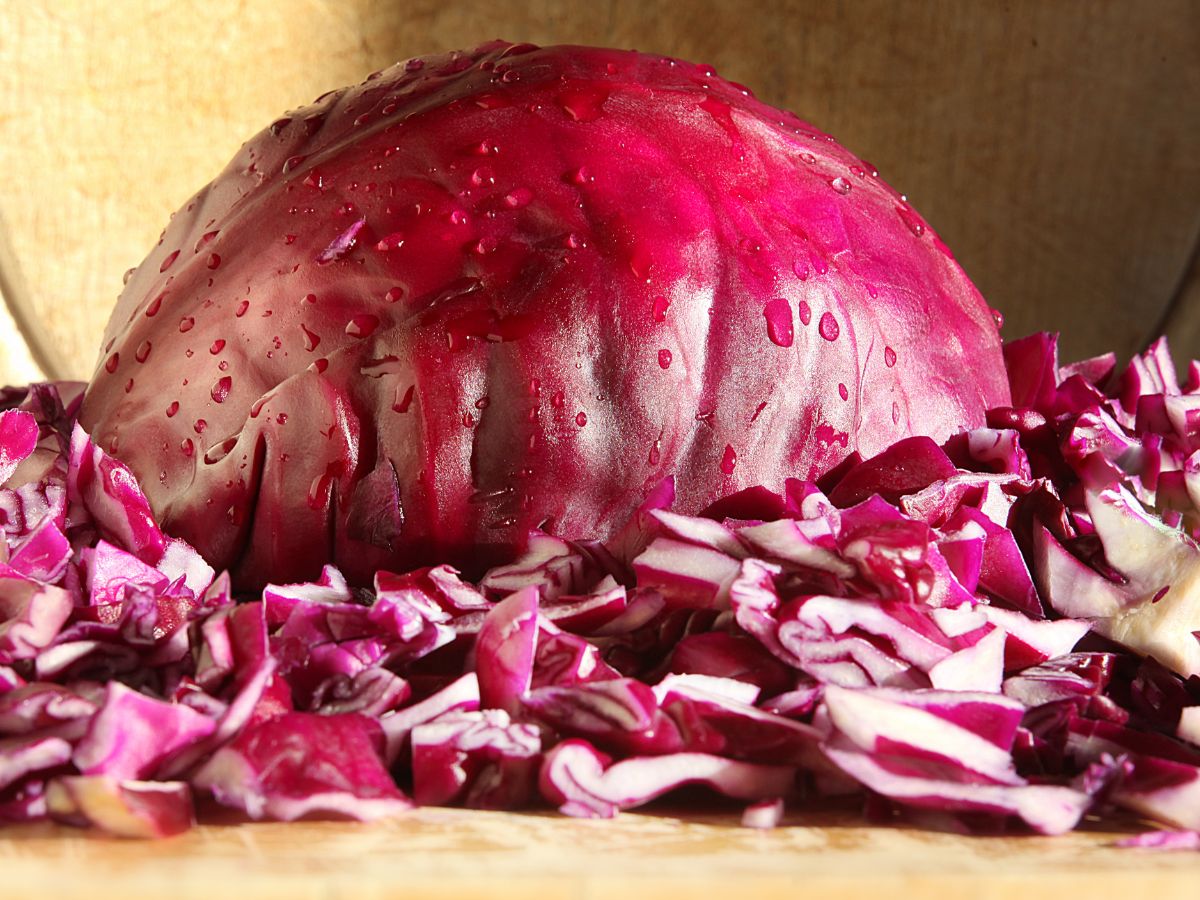 Sliced red cabbages on a wooden cutting board.