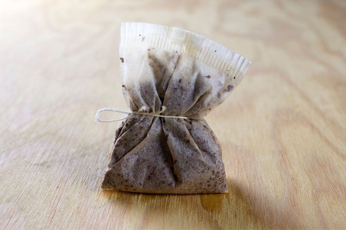 A used bag of tea on a table.