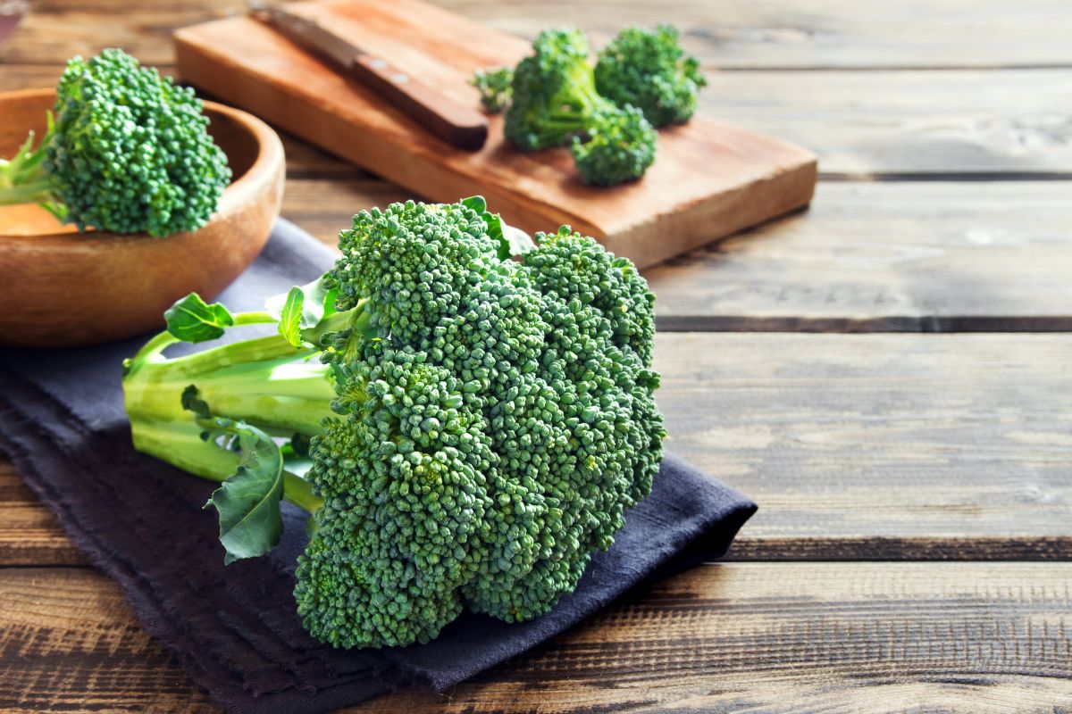 Fresh organic broccoli on a wooden table.