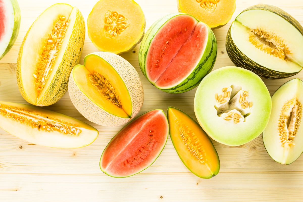 Different varieties of melons on a table.