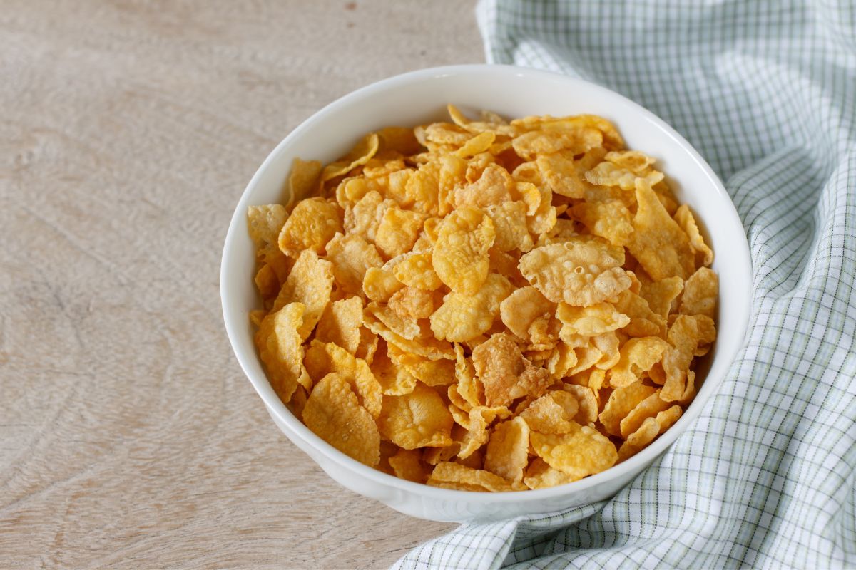 A white bowl full of cereals on a table.