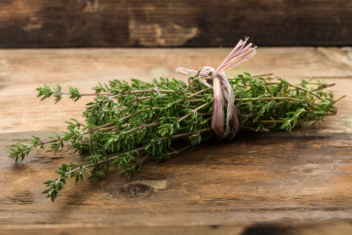 A pack of thyme on a wooden table.
