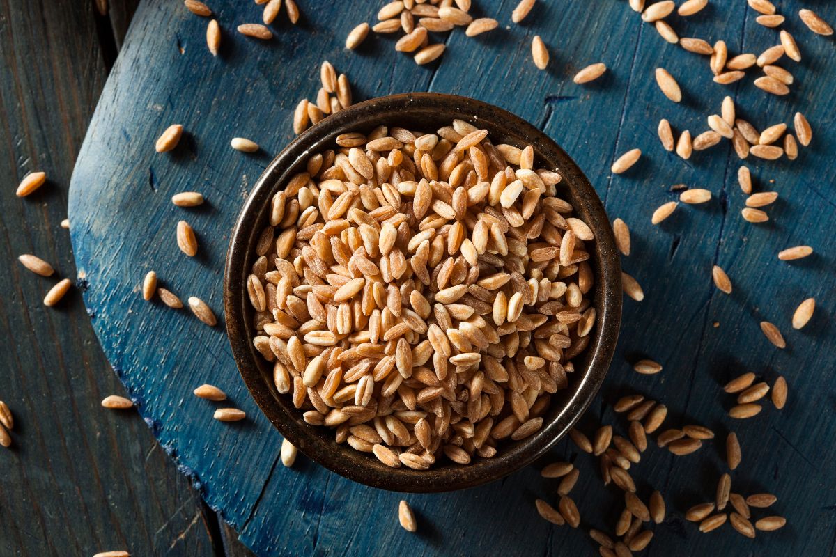 A bowl full of organic grains on a table.