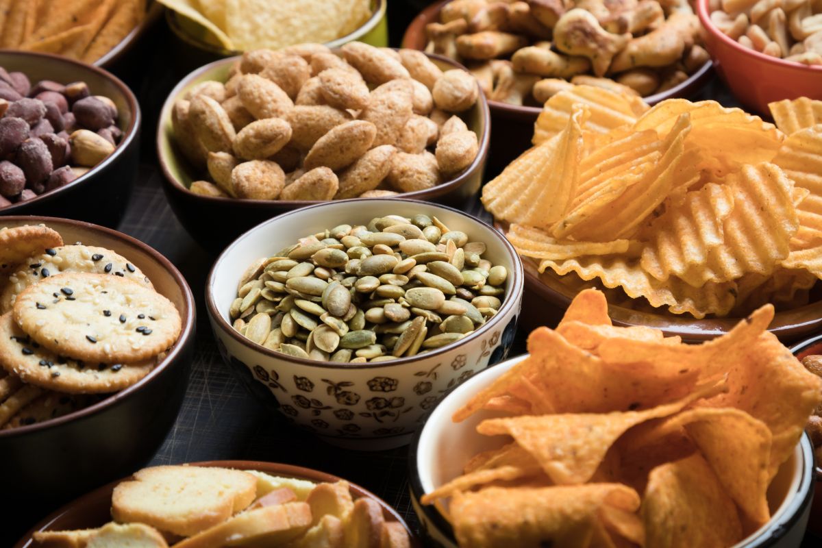 Bowls full of different varieties of salty snacks.