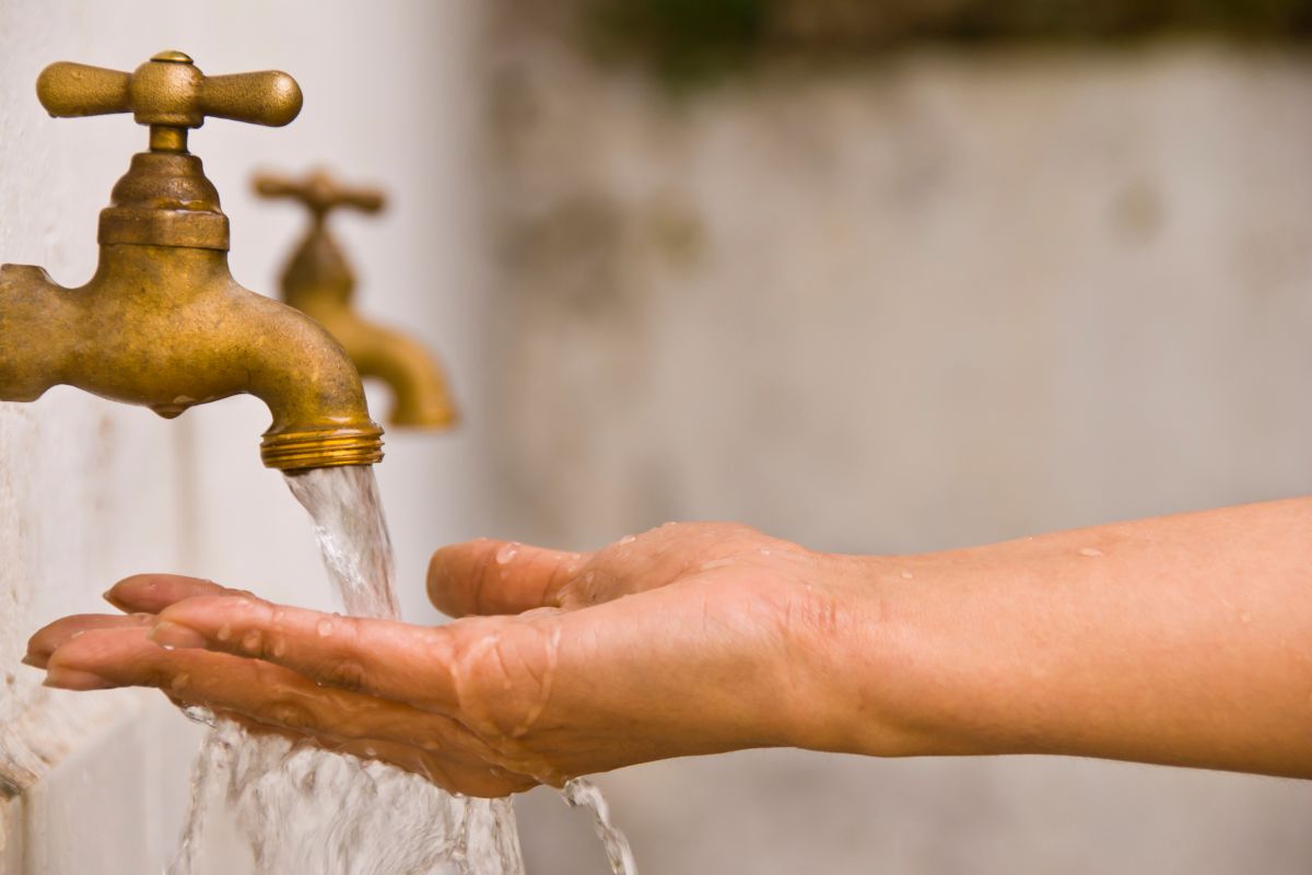 Tap water pouring on a hand.