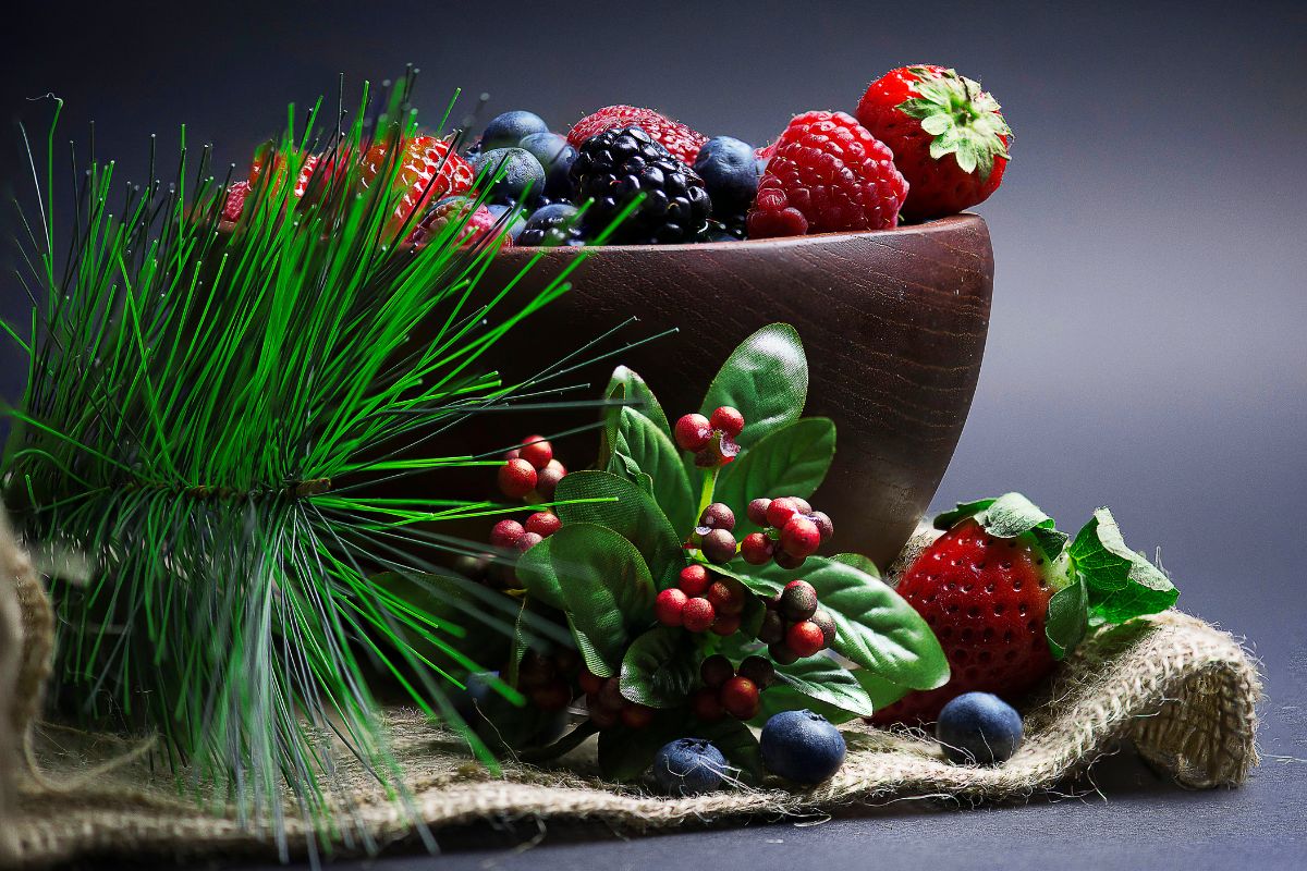 A bowl full of ripe berries on a table.